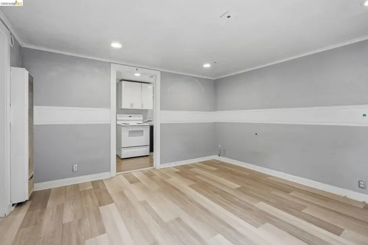 Light wood-finish flooring complements the two-tone walls with white chair rail molding