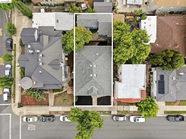 Aerial perspective showcasing a multi-unit property with a gabled roofline