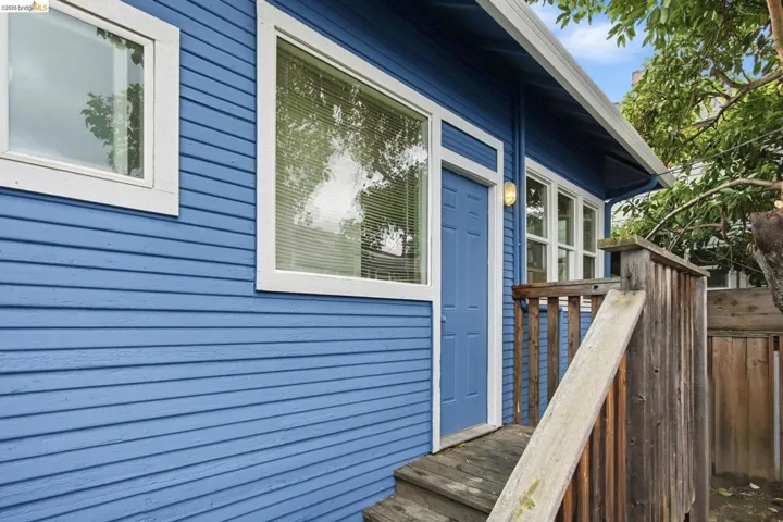 Blue lap siding exterior featuring white trim windows
