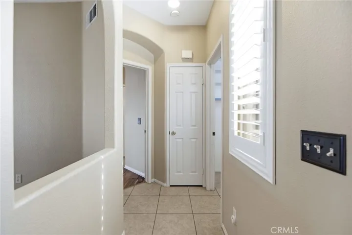 Hallway toward Primary Bedroom on left side open door. Closed door is Linen Closet. Right side open door is Laundry Room.