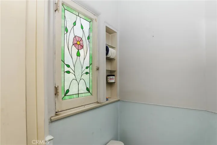 stain glass window in downstairs half bath in front bedroom