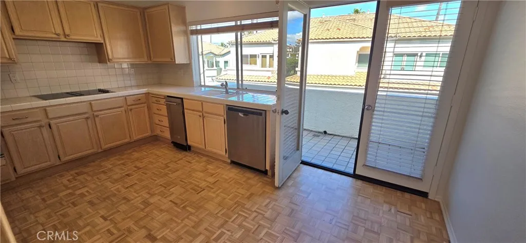 Kitchen with breakfast nook area leads to patio.
