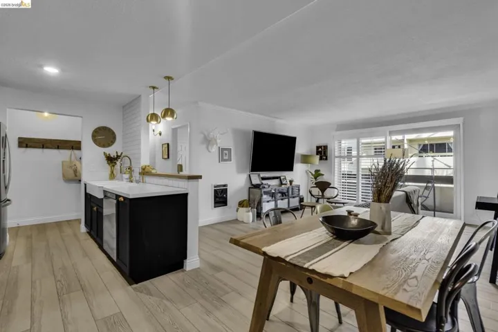 Open-concept living space with light wood-finish flooring