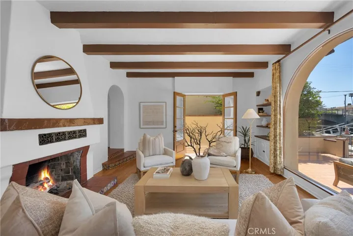 Living Room with warm romantic fireplace and double doors leading to entertaining patio with canal views
