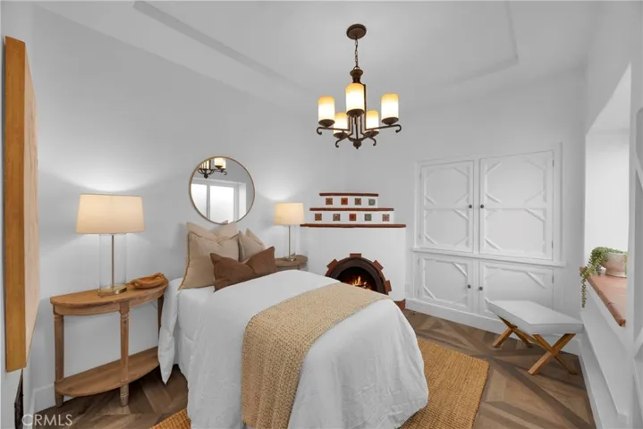 Downstairs bedroom/den/office with fireplace and built-ins