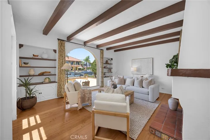 Spacious living room with beamed ceilings and built-ins
