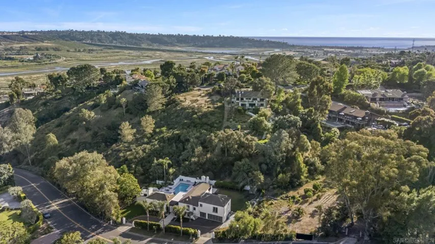 A rare hillside setting surrounded by mature landscape and open natural vistas, where elevated positioning captures sweeping views stretching toward the coastline and the beauty of North County’s iconic coastal terrain.