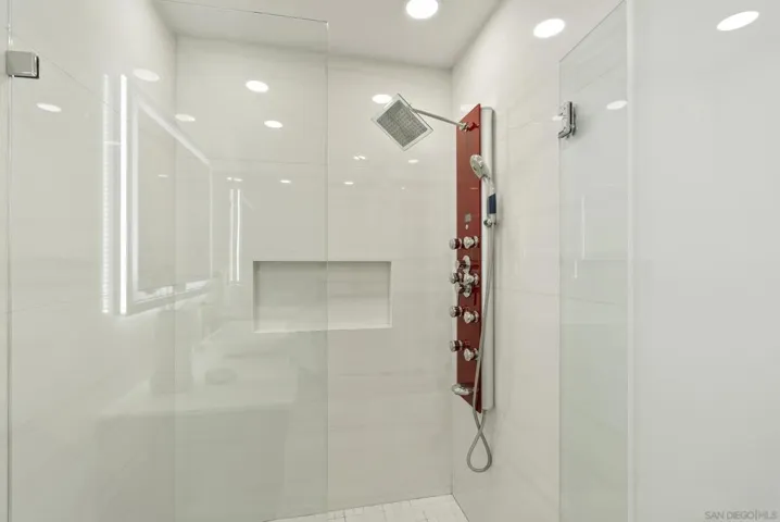 A spacious glass enclosed shower with clean contemporary finishes and a multi function rainfall and body sprayer system, designed to deliver a polished and spa inspired guest experience.