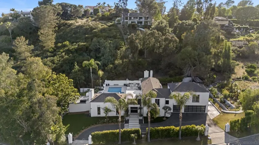 A striking aerial perspective showcases the estate’s commanding presence, where modern architecture, expansive grounds, and lush canyon surroundings come together in a rare and private hillside setting.