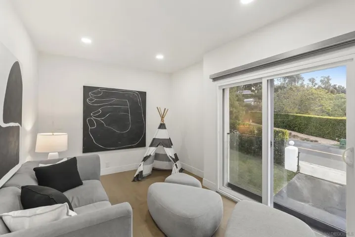 A flexible private studio or office space with serene natural views, warm contemporary finishes, and direct outdoor access, offering an ideal setting for work, relaxation, or creative retreat.