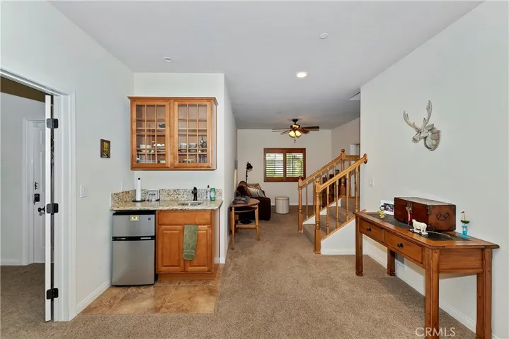 Area right off the stairs with a small kitchenette and another sitting area