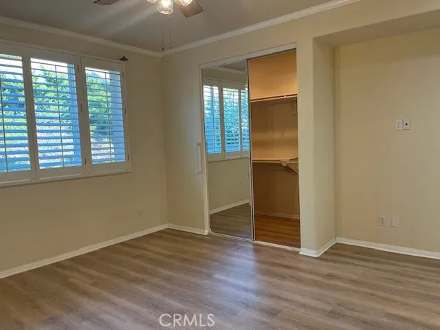 Primary Bedroom Walk-in Closet has Mirrored Wardrobe Doors
