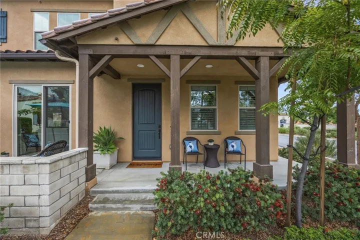 Front door with front porch and a separate patio