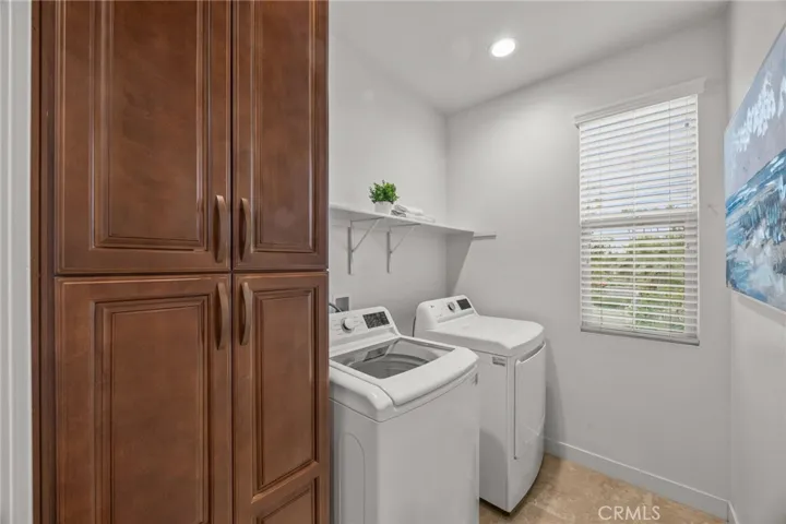 Laundry Room with ample storage cabinets and shelf.