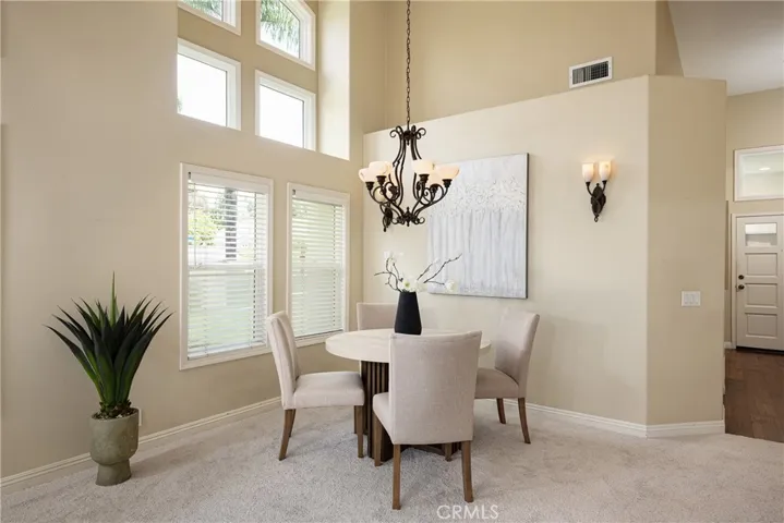 The dining area is enhanced with a vaulted ceiling and wall sconces.