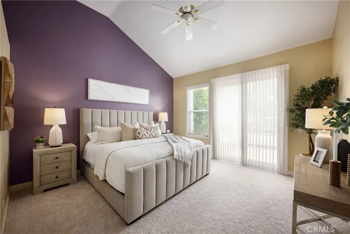 The primary suite offers new carpet, vaulted ceiling, and direct patio access.