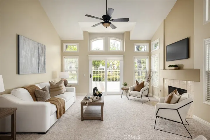 The living room features a sliding door leading to the back patio and overlooks a beautiful, expansive greenbelt.