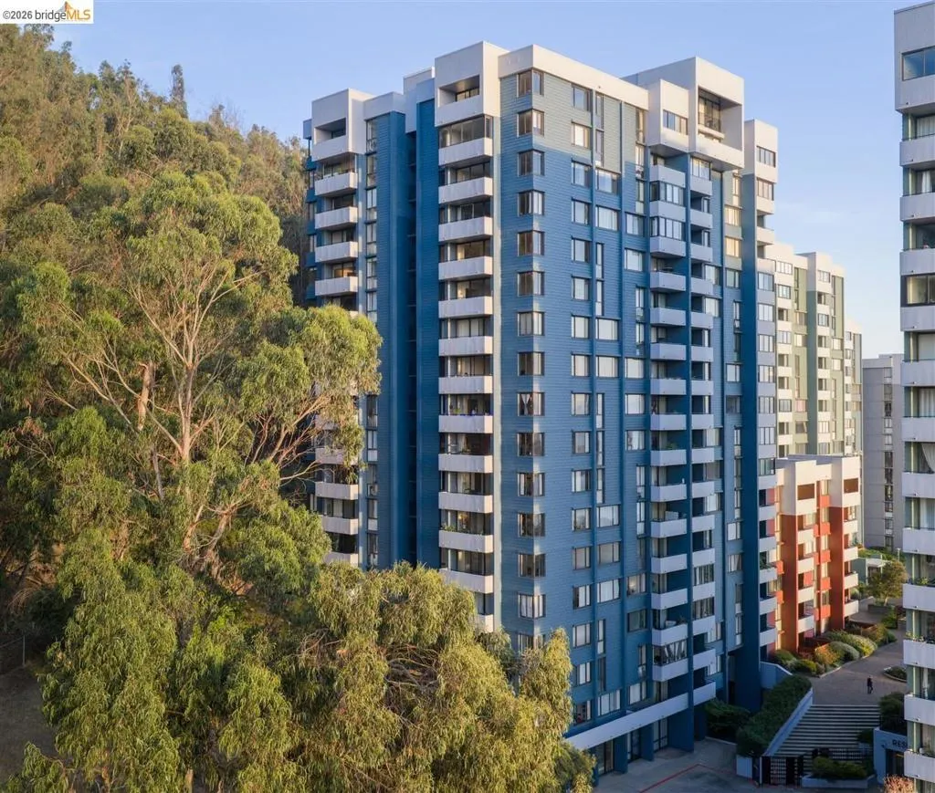 Multi-story residential building featuring a blue and white facade