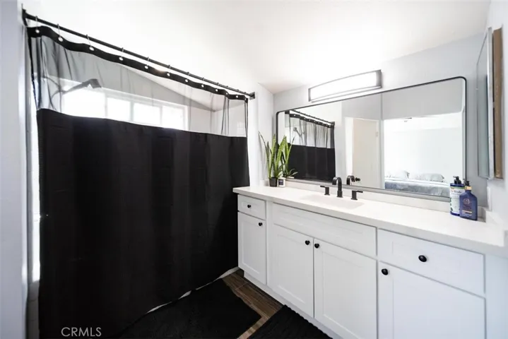 primary bathroom with LVP floors and upgraded counters and fixtures