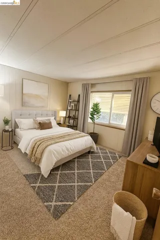 Bedroom with carpet, wood walls, and a textured ceiling
