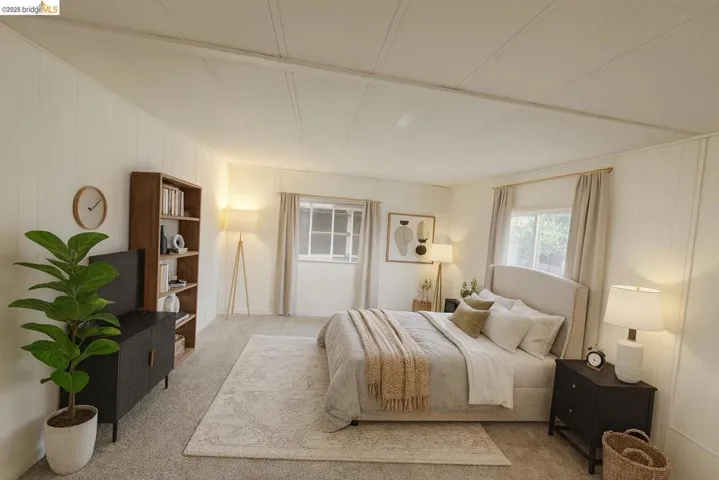 Carpeted bedroom with wood walls
