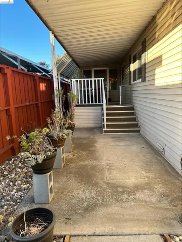 Fenced backyard with a patio area