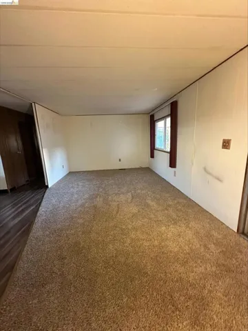 Empty room with dark colored carpet