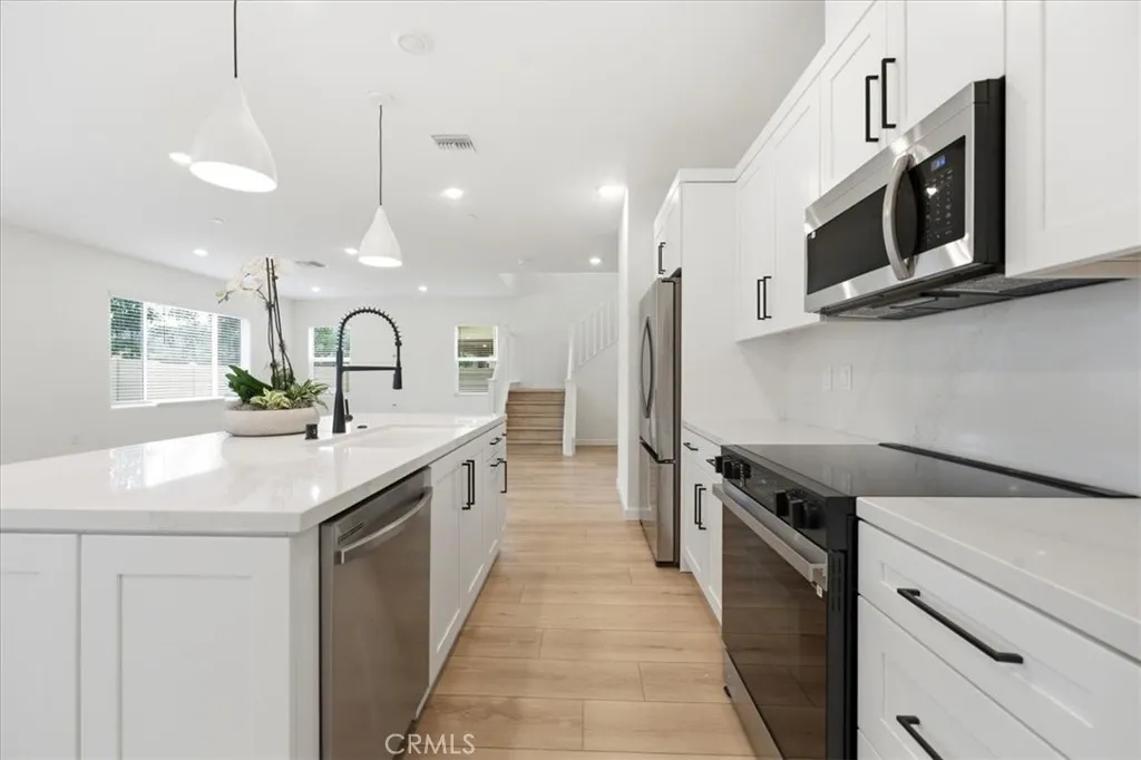 Designer Kitchen with appliances & pendant Lighting