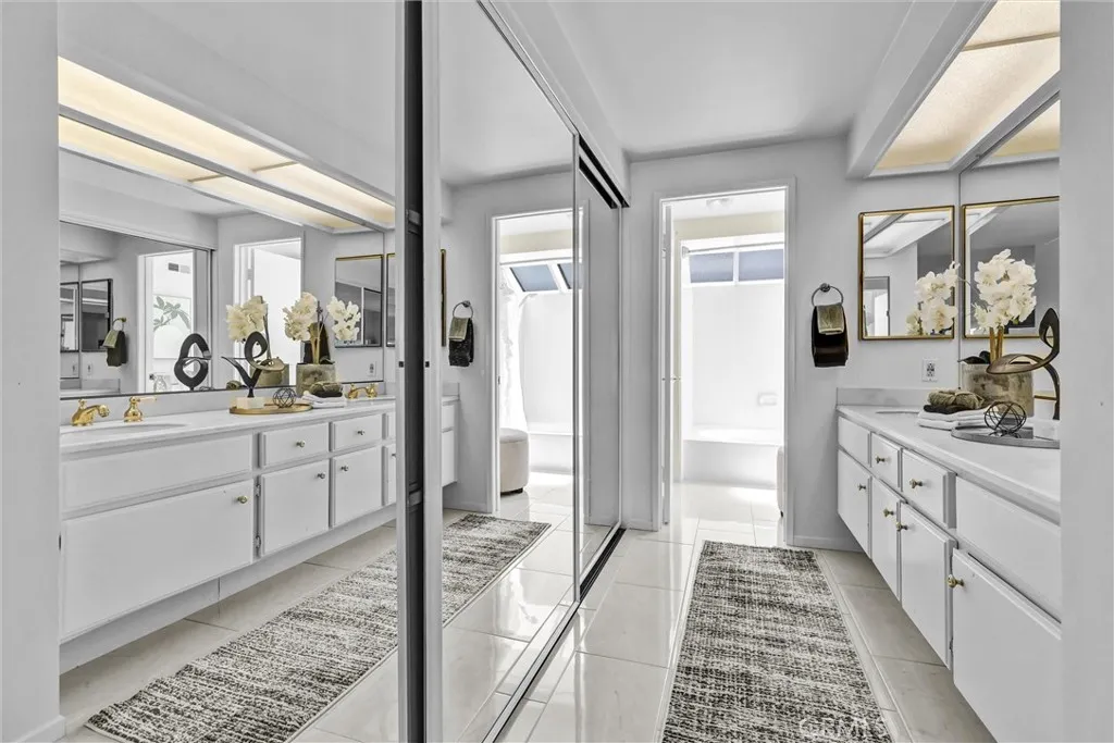 Large closet with expansive three mirrored door panels