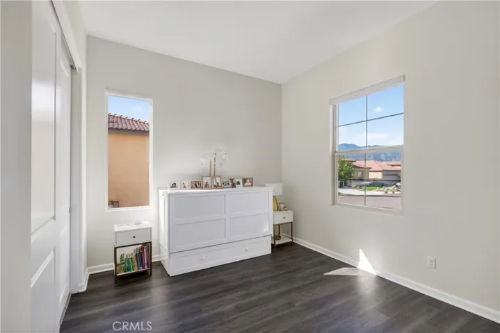 large guest bedroom with continued LV flooring
