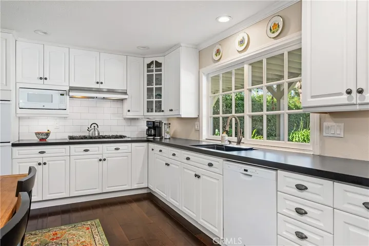 Look out your kitchen sink window at the beautiful backyard.
