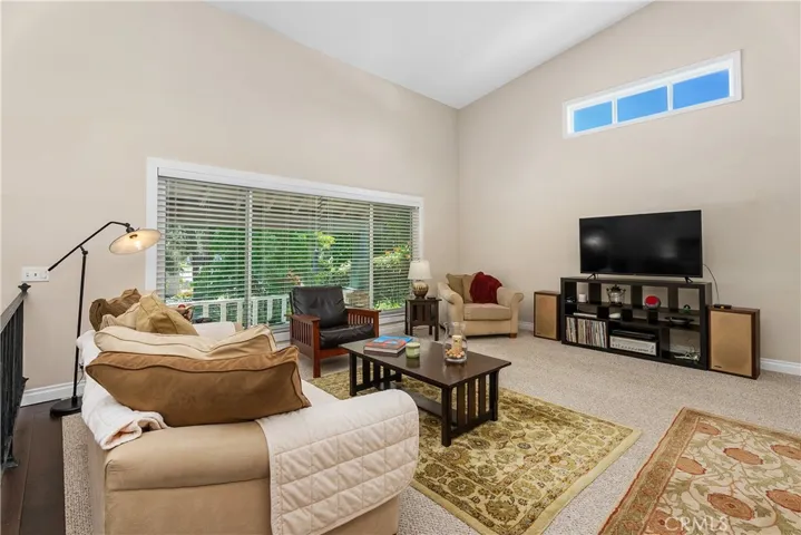 Looking out the formal living room window to beautiful trees out front & covered porch.