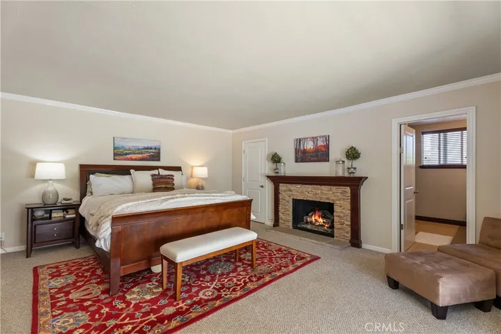 Primary bedroom with wood burning fireplace.