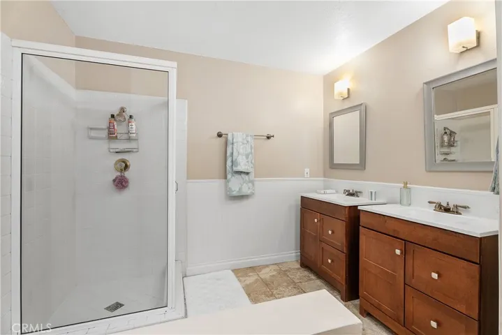 Full bathroom off upstairs hallway with shower, tub and double sinks with storage.
