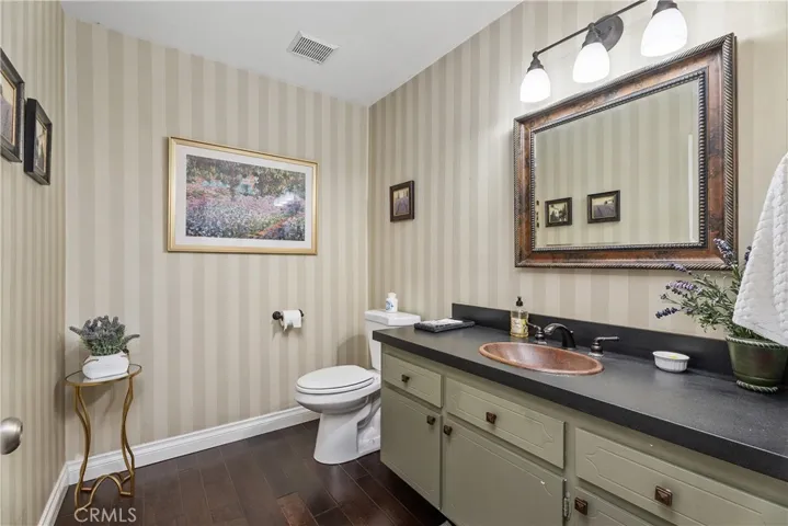 Downstairs 1/2 bath off hallway near door leading to 3 car garage.