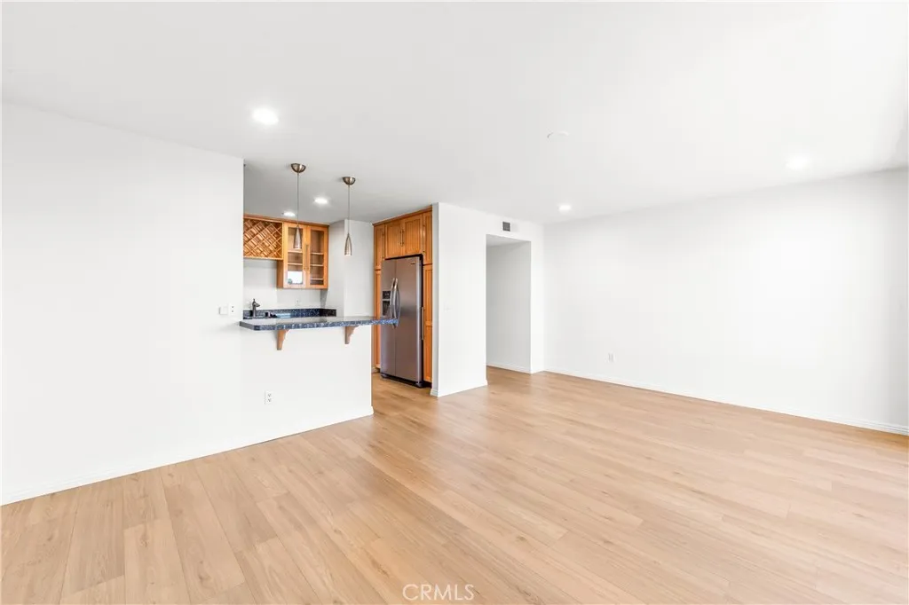Kitchen opens to living room and balcony