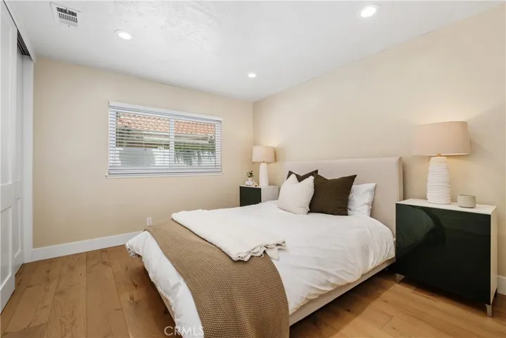 LARGE DOWNSTAIRS BEDROOM, BEAUTIFUL WOOD FLOORING, NEW BLINDS, RECESSED LIGHTING AND FUNCTIONAL CLOSET ORGANIZERS.