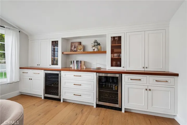 CUSTOM BUILT-IN BAR AND CABINET IN THE DINING ROOM. WITH TWO BEVERAGE/WINE RFRIGERATORS.