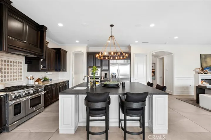 Gourmet kitchen w/ large leathered granite countertops, double oven, 2 sinks, walk in pantry and butlers' walkway.