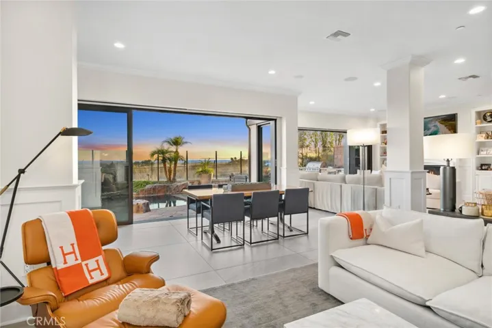 Double sides of stacked glass doors open up the home to endless views.
