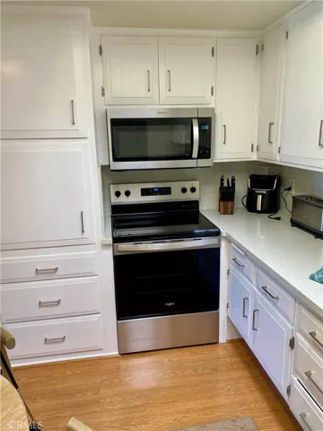updated kitchen with electric range and microwave
