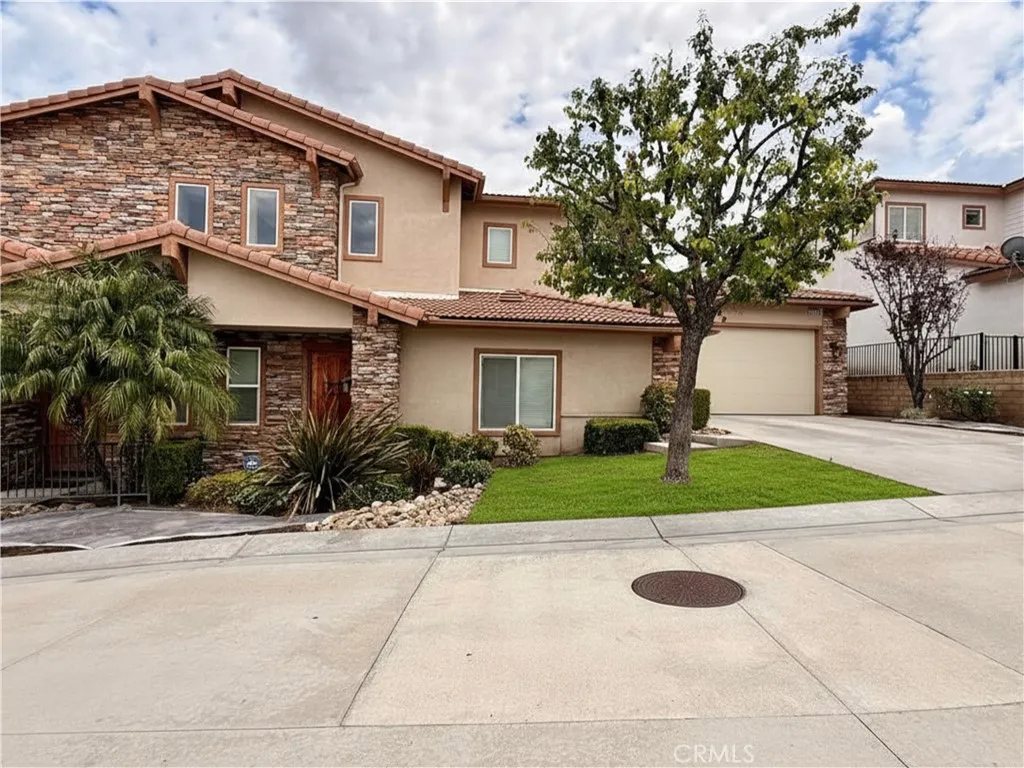 Exterior of condo with driveway. Grass is virtually modified- landscaping is fixing it at the moment.