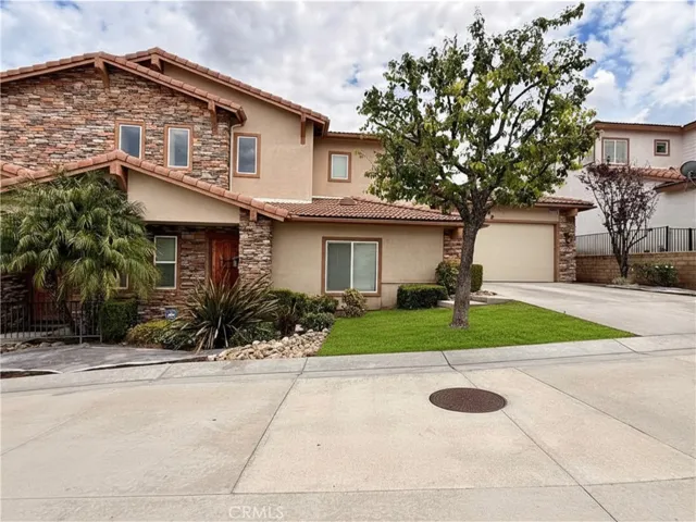 Exterior of condo with driveway. Grass is virtually modified- landscaping is fixing it at the moment.