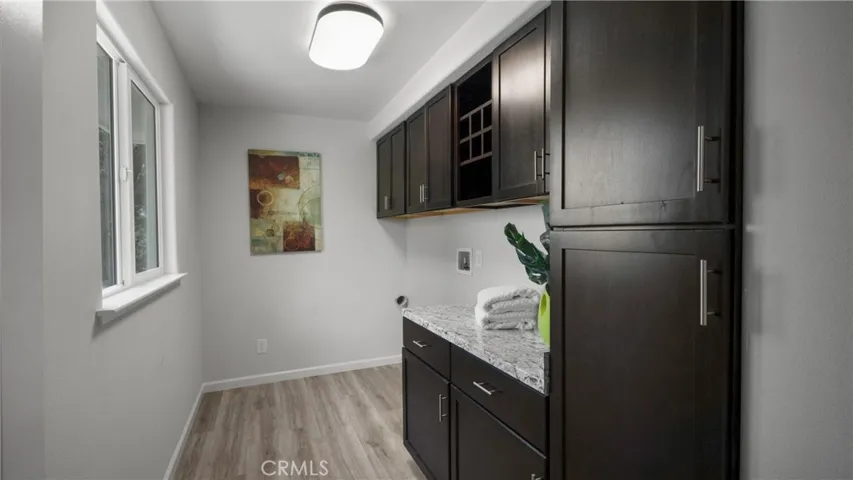 Laundry room with lots of work space and storage.