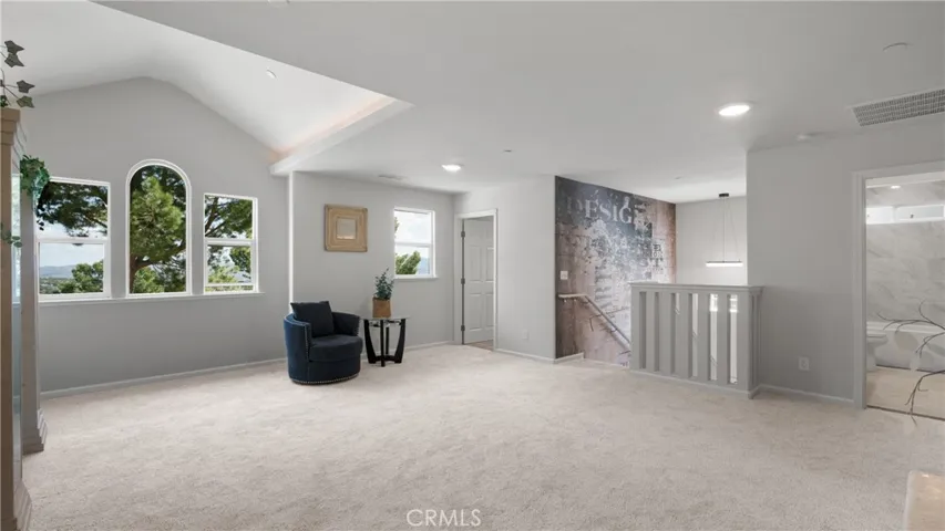 Great room upstairs with nice views of the Lake and Mountains. From here, you have the primary bedroom suite, two additional bedrooms, and one more bathroom.