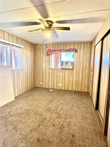 Primary bedroom with Cabinetry to the right from doorway to the end of the room