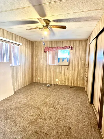 Primary bedroom with Cabinetry to the right from doorway to the end of the room