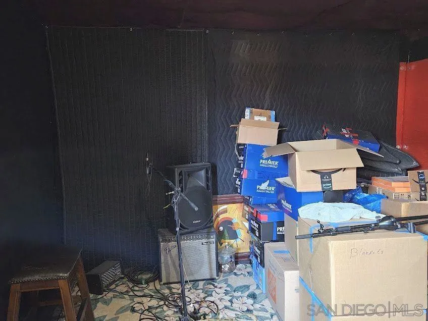 The large outbuilding in the backyard is currently being used for storage, but it most recently served as a music room.