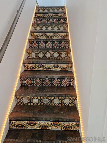 Illuminated stairs leading to primary bedroom.