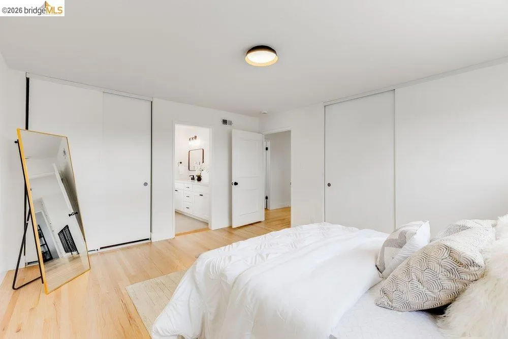 Light wood-finish flooring complements white walls